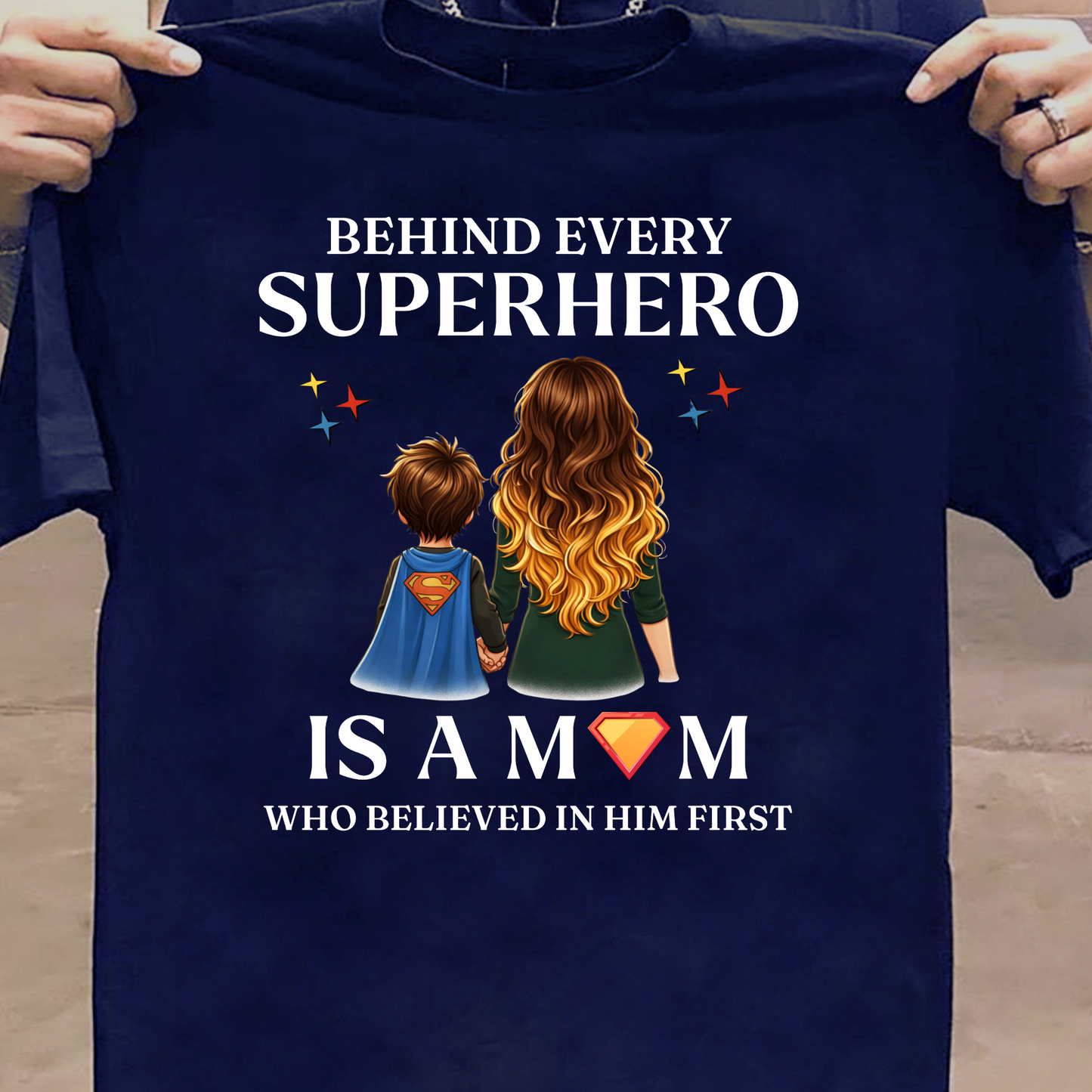 BEHIND EVERY SUPERHERO IS A MOM WHO BELIEVED IN HIM FIRST (MOTHER) CLASSIC T-SHIRT