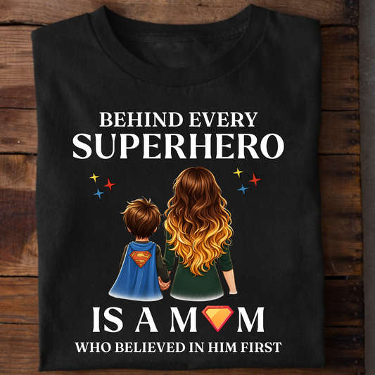 BEHIND EVERY SUPERHERO IS A MOM WHO BELIEVED IN HIM FIRST (MOTHER) CLASSIC T-SHIRT